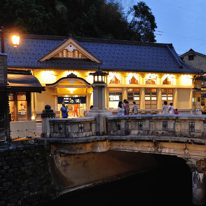 Ichinoyu Onsen's exterior. The large beige stone building, with it's black tiled roof is impressive