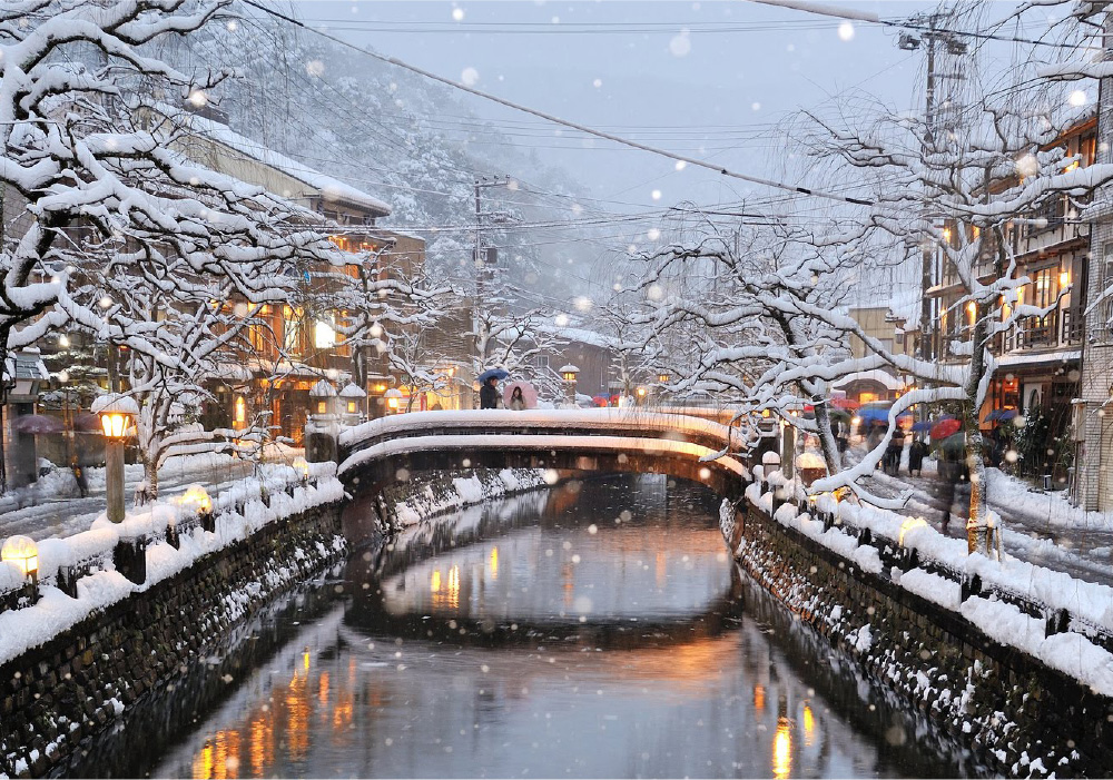 Kinosaki Onsen river and stone bridges during heavy snowfall