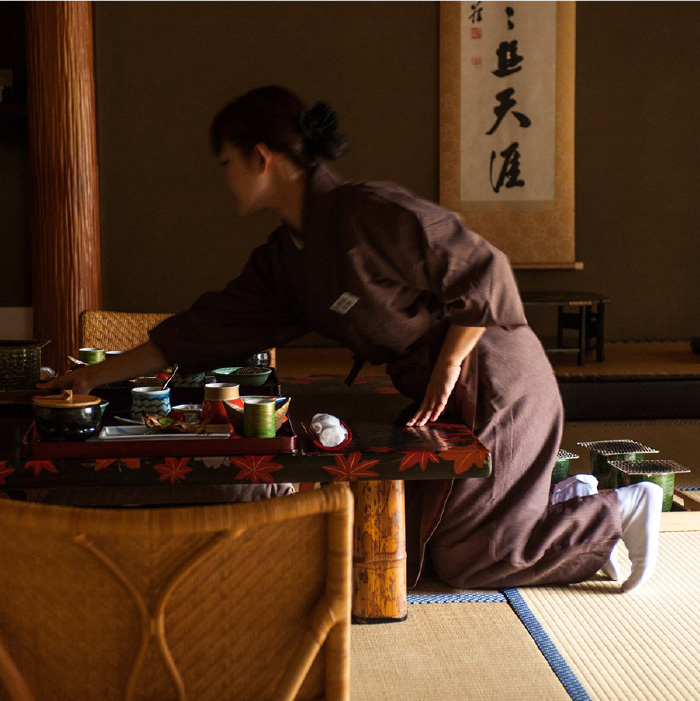 A woman cleaning up a table