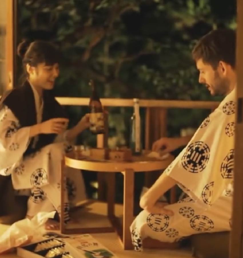 A couple enjoying sake together in Yukata on tatami floor in a private ryokan bedroom