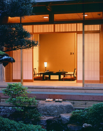 A private look into a ryokan bedroom. Photo taken from the private outdoor Japanese garden of the room, looking inwards