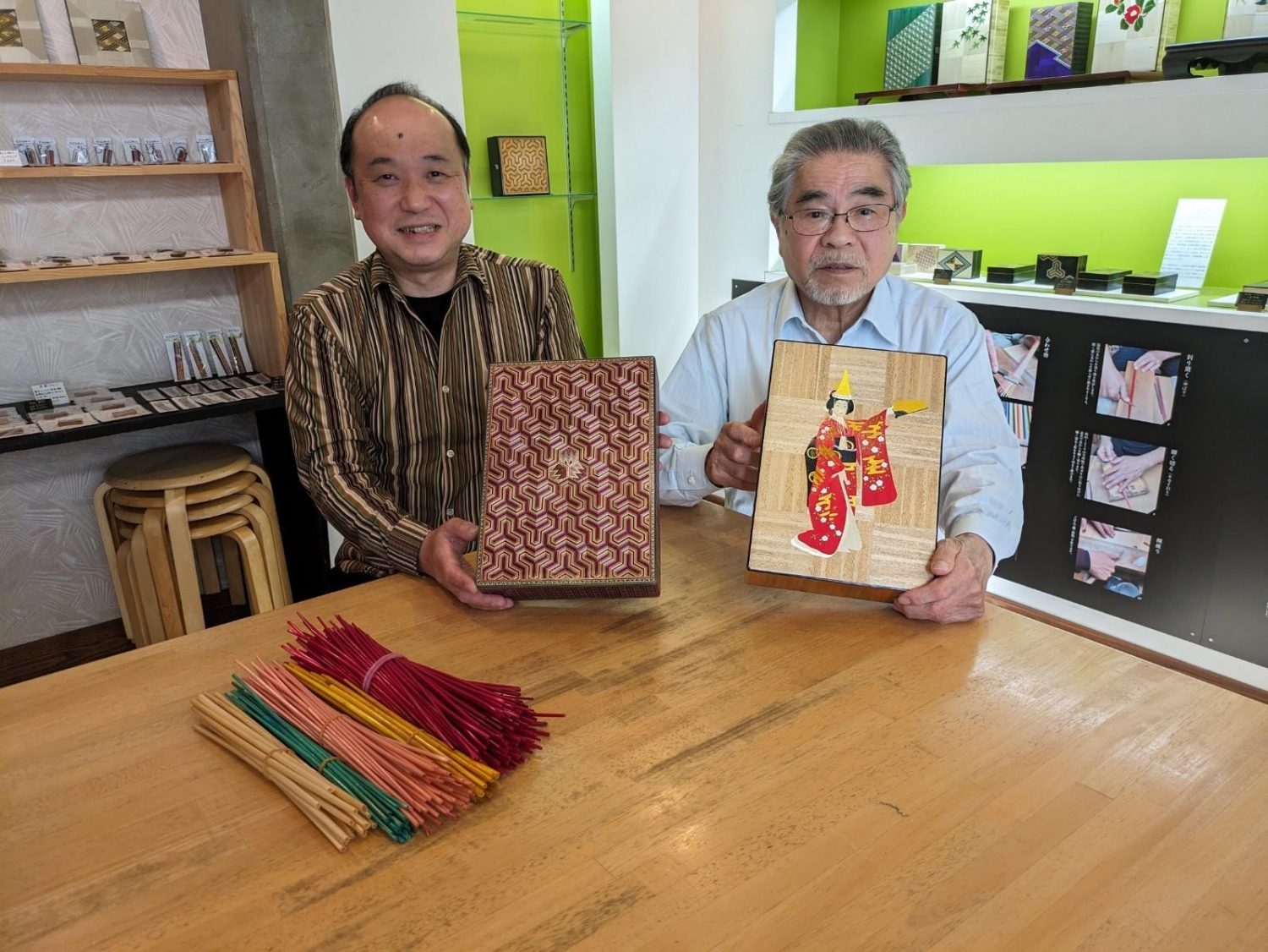 Mister Kamiya and his father, Masaru, pose with their past works