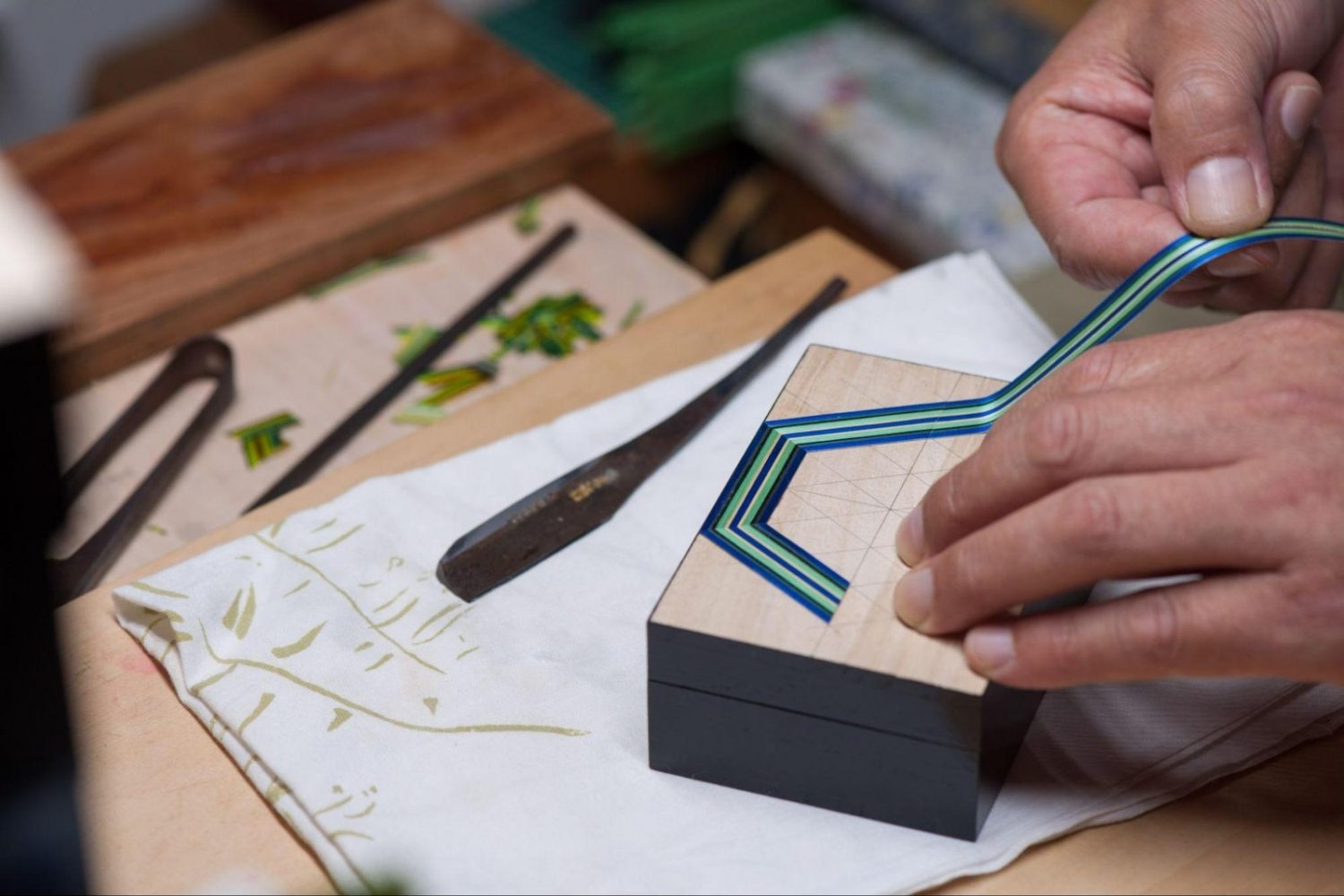 Mister Kamiya begins the precise design process for a straw craft box